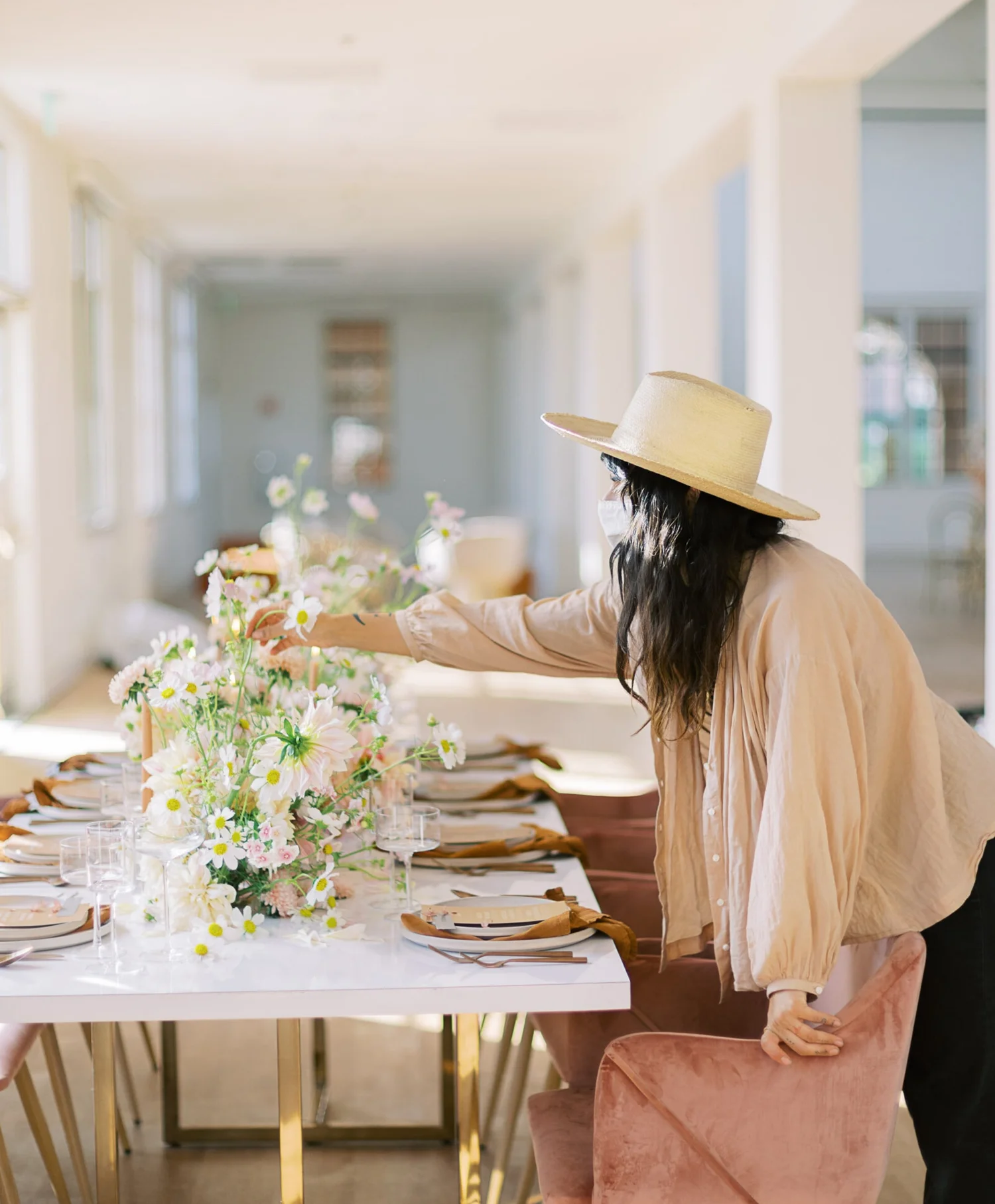 Rachael styling a wedding tablescape for Siren Floral Co.