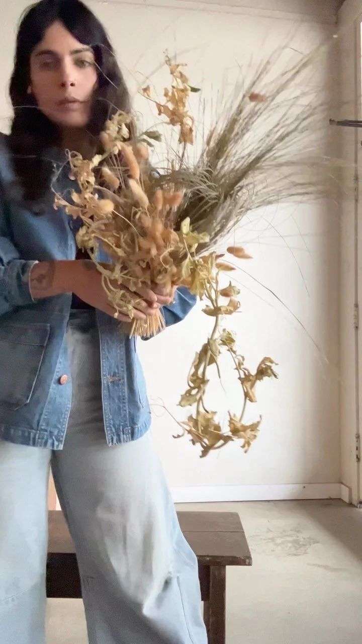 Studio portrait with a sculptural dried arrangement