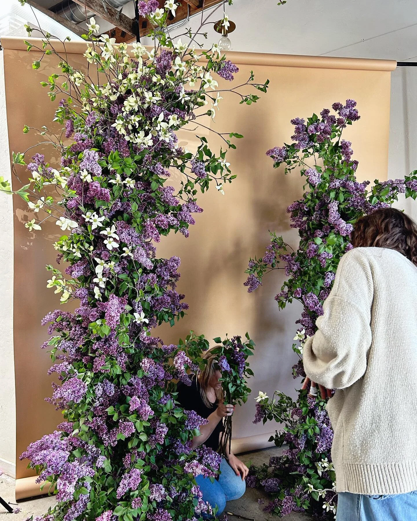 Climbing floral wall installation in purple and green