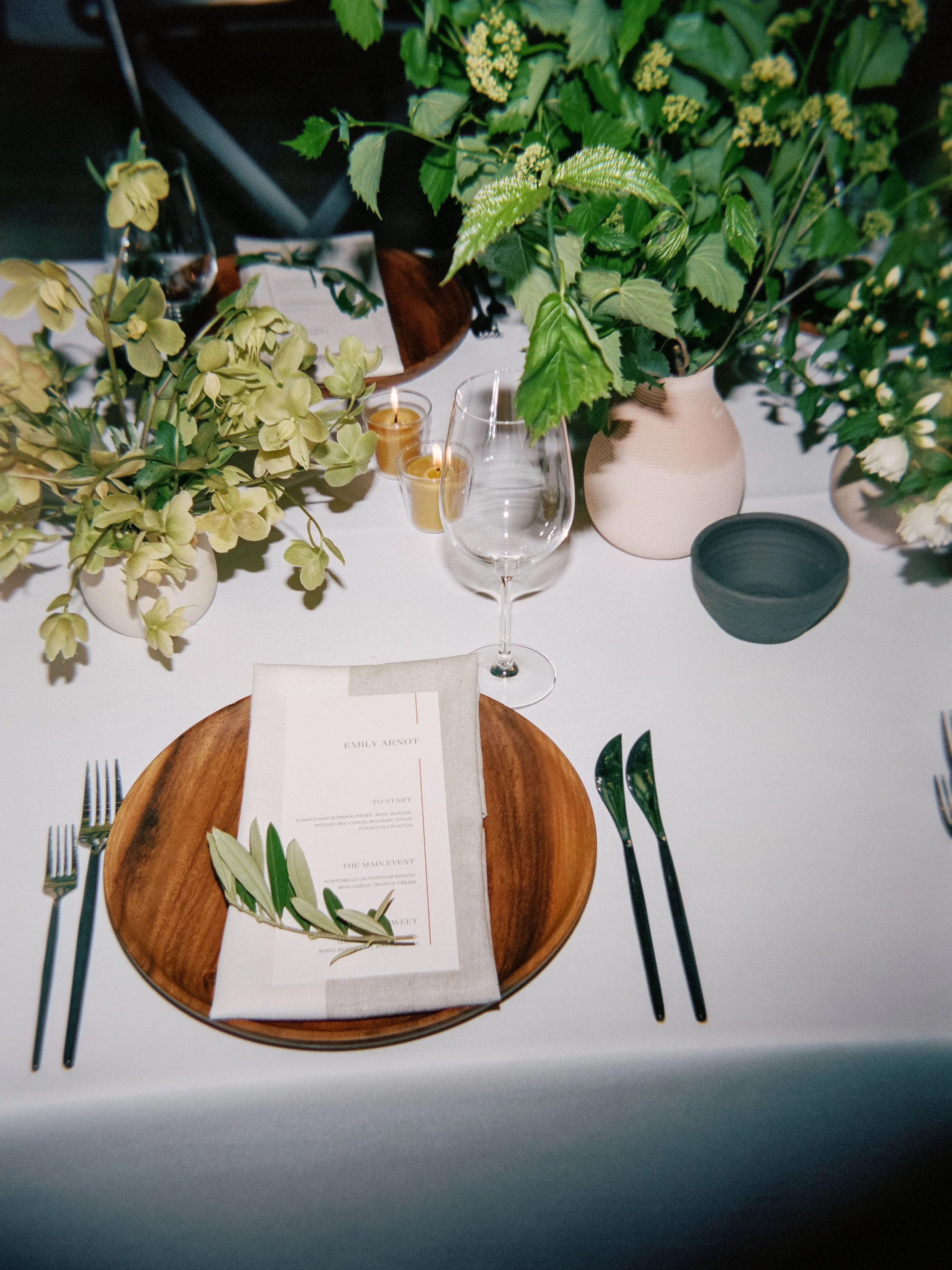 Reception tablescape with lush centerpiece and place setting