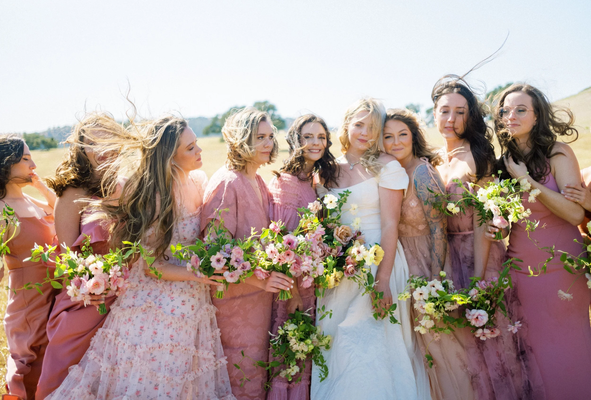 Bridesmaids with soft seasonal bouquets
