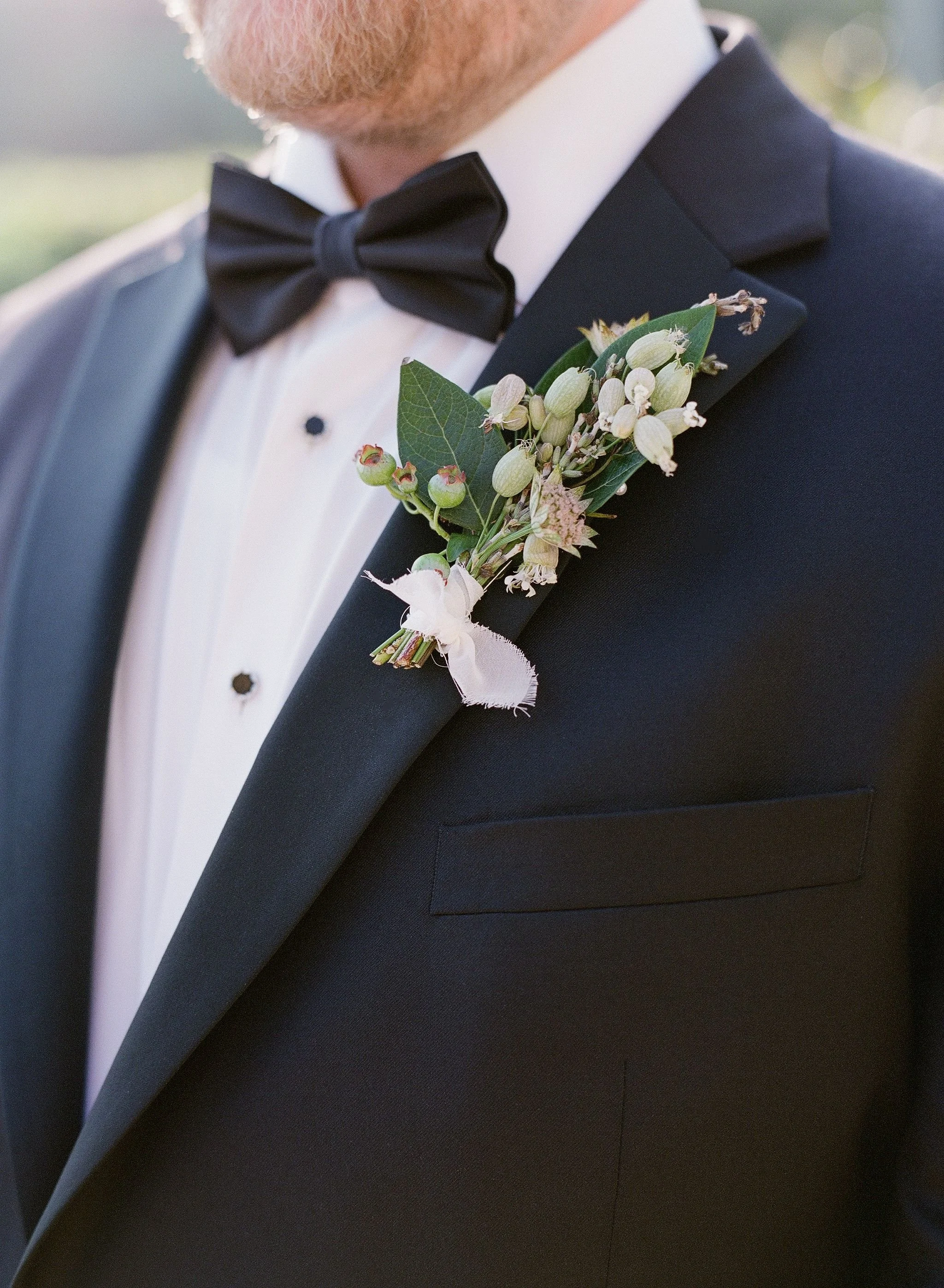 Delicate boutonniere on a groom's tuxedo
