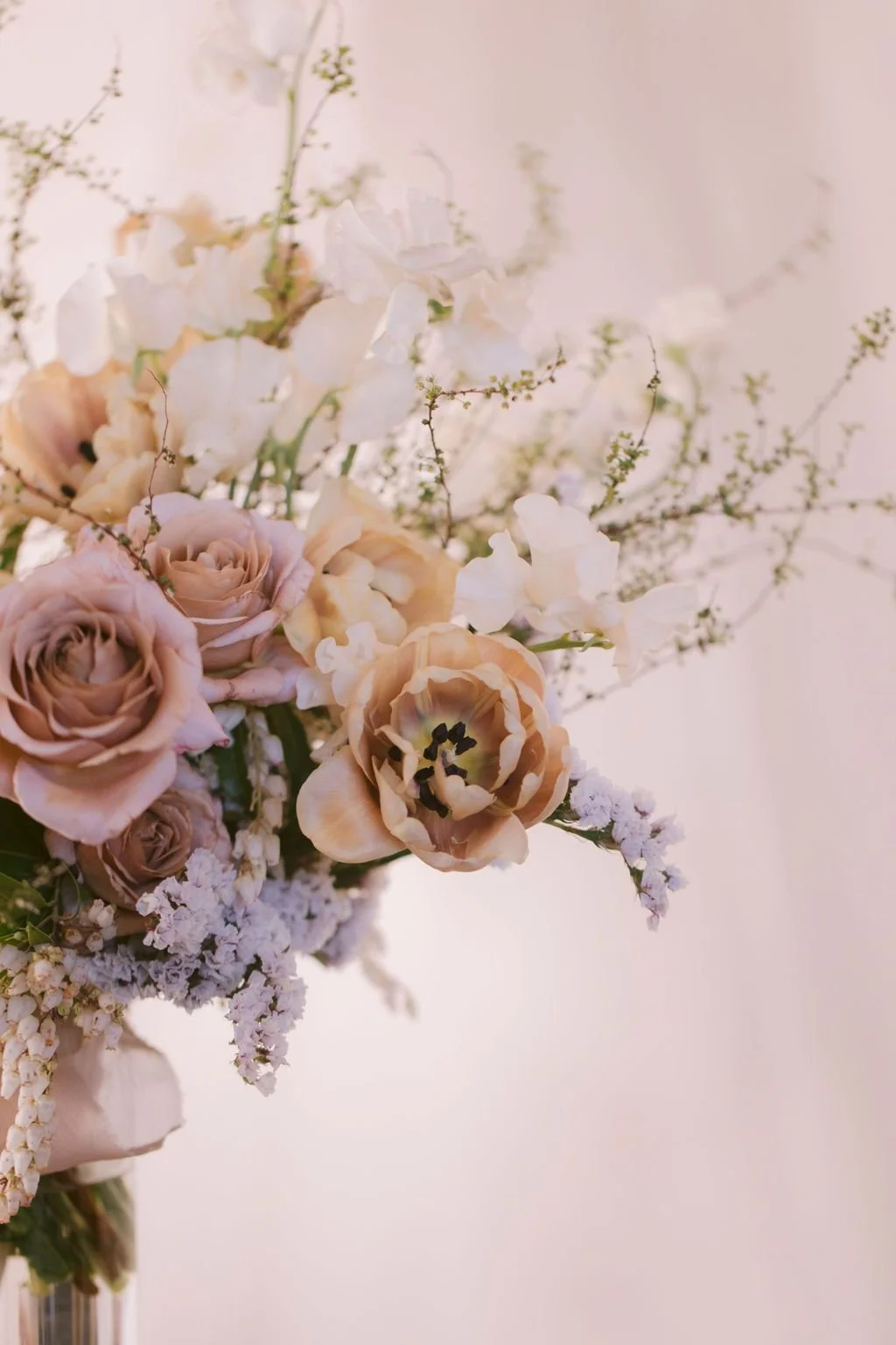 Airy arrangement of roses and blossoming branches